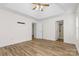 Spacious main bedroom with wood-look floors, ceiling fan, and access to the bathroom at 131 Canopy Ct, Mooresville, NC 28115