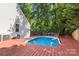 Backyard pool with wooden deck, surrounded by mature trees offers a tranquil oasis for outdoor enjoyment at 131 Canopy Ct, Mooresville, NC 28115