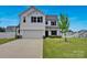 Charming two-story home featuring a well-manicured lawn and attached two-car garage at 1315 Elizabeth Ave, Kannapolis, NC 28083
