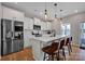 Modern kitchen with white cabinets, stainless steel appliances, and a large center island with seating at 1315 Elizabeth Ave, Kannapolis, NC 28083