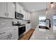 Modern kitchen boasts white cabinets, stainless steel appliances, and quartz countertops at 1315 Elizabeth Ave, Kannapolis, NC 28083