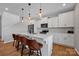 Well-lit kitchen featuring a spacious island with barstool seating and stainless steel appliances at 1315 Elizabeth Ave, Kannapolis, NC 28083