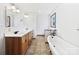 Bright bathroom with a double sink vanity, standalone tub, tile flooring, and natural light at 132 Windy Hill Rd, Statesville, NC 28625