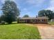 Charming single-story home with brick and vinyl siding, complemented by mature landscaping and a sunny front yard at 132 Windy Hill Rd, Statesville, NC 28625