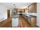 Well-lit kitchen with wooden cabinets, stainless steel appliances, granite countertops and a kitchen island at 132 Windy Hill Rd, Statesville, NC 28625