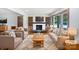 Bright living room with fireplace, hardwood floors, built-ins, and large windows for natural light at 132 Windy Hill Rd, Statesville, NC 28625