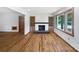 Bright living room with fireplace, hardwood floors, built-ins, and large windows for natural light at 132 Windy Hill Rd, Statesville, NC 28625