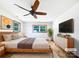 Light-filled bedroom featuring hardwood floors, a ceiling fan, neutral walls, and a large window at 132 Windy Hill Rd, Statesville, NC 28625