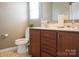 Bathroom featuring dual sinks, warm colored cabinets, and modern fixtures at 14411 Glendon Hall Ln, Charlotte, NC 28262