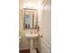 Bathroom featuring a pedestal sink, decorative mirror, towel rack and neutral wall color at 14411 Glendon Hall Ln, Charlotte, NC 28262