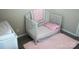 Bedroom featuring a crib, pink rug, and neutral paint color at 14411 Glendon Hall Ln, Charlotte, NC 28262
