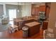 Open kitchen featuring stainless appliances, wood cabinets, granite countertops, and a central island at 14411 Glendon Hall Ln, Charlotte, NC 28262
