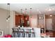 Open kitchen with stainless appliances, wood cabinets, granite countertops, and eat-in bar at 14411 Glendon Hall Ln, Charlotte, NC 28262
