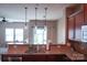 Kitchen with wood cabinets, granite countertops, stainless steel appliances, and open to living room at 14411 Glendon Hall Ln, Charlotte, NC 28262