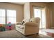 Comfortable living room with neutral walls, plush carpet, and sliding glass door to backyard at 14411 Glendon Hall Ln, Charlotte, NC 28262