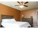Bedroom with neutral walls, ceiling fan, and a wooden dresser and bed frame at 14411 Glendon Hall Ln, Charlotte, NC 28262