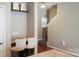 Home office nook with built-in desk and a comfortable chair, next to staircase at 14411 Glendon Hall Ln, Charlotte, NC 28262