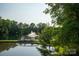 Scenic pond view with a charming bridge and a fountain, surrounded by lush greenery at 14411 Glendon Hall Ln, Charlotte, NC 28262
