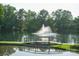 Scenic pond view featuring a fountain and footbridge amid lush greenery at 14411 Glendon Hall Ln, Charlotte, NC 28262