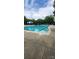 Community pool with marked lanes, lounge chairs, umbrellas, and well-kept concrete surround at 14411 Glendon Hall Ln, Charlotte, NC 28262