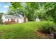 Large grassy backyard with treeline and storage shed at 1512 Anthony Dr, Gastonia, NC 28052