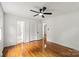 Bedroom with hardwood floors, ceiling fan, and access to ensuite bathroom at 1512 Anthony Dr, Gastonia, NC 28052