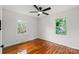 Bedroom with hardwood floors, two windows offering natural light, and a ceiling fan at 1512 Anthony Dr, Gastonia, NC 28052