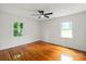Sunlit bedroom with hardwood floors, two windows, and a ceiling fan at 1512 Anthony Dr, Gastonia, NC 28052