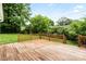 Wooden deck surrounded by green grass and trees at 1512 Anthony Dr, Gastonia, NC 28052
