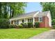 Charming home featuring a well-manicured lawn, front porch, and brick accents at 1512 Anthony Dr, Gastonia, NC 28052