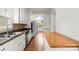 Bright eat-in kitchen featuring stainless appliances, wood floors, and good natural light at 1512 Anthony Dr, Gastonia, NC 28052