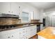 Well-lit kitchen boasts stainless appliances, ample cabinetry, and attractive backsplash at 1512 Anthony Dr, Gastonia, NC 28052