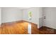 Bright living room with gleaming hardwood floors and a fresh, neutral color palette at 1512 Anthony Dr, Gastonia, NC 28052