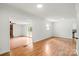 Bright living room with hardwood floors, white walls, and access to kitchen and outdoor space at 1512 Anthony Dr, Gastonia, NC 28052