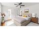 Stylized main bedroom with ensuite bathroom access, hardwood floors, and a large bed at 1512 Anthony Dr, Gastonia, NC 28052