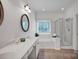 The bathroom features a tub, a shower, and large vanity with a countertop sink at 16013 Wynfield Creek Pkwy, Huntersville, NC 28078