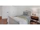 This bedroom features a comfortable bed with a floral comforter, a wooden bedside table, and white trim throughout at 16013 Wynfield Creek Pkwy, Huntersville, NC 28078
