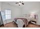 A cozy bedroom featuring a ceiling fan, window with blinds, and a comfortable bed with a pink throw blanket at 16013 Wynfield Creek Pkwy, Huntersville, NC 28078