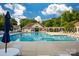 A large, inviting community pool surrounded by lounge chairs, umbrellas, and a clubhouse in the background at 16013 Wynfield Creek Pkwy, Huntersville, NC 28078