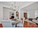 Formal dining area featuring hardwood floors, a modern chandelier, and views to the living area at 16013 Wynfield Creek Pkwy, Huntersville, NC 28078