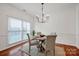 Elegant dining room showcasing a modern chandelier, hardwood floors, and classic trim at 16013 Wynfield Creek Pkwy, Huntersville, NC 28078