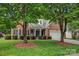 Beautiful brick home with a manicured front lawn and mature trees at 16013 Wynfield Creek Pkwy, Huntersville, NC 28078