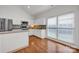 Well-lit kitchen with white cabinets, stainless steel appliances, and a cozy breakfast nook at 16013 Wynfield Creek Pkwy, Huntersville, NC 28078