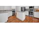 Modern kitchen featuring stainless steel appliances, an island, and ample counter space at 16013 Wynfield Creek Pkwy, Huntersville, NC 28078