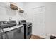 This laundry room features tile floors, overhead storage, and a door for easy access to the outside at 16013 Wynfield Creek Pkwy, Huntersville, NC 28078