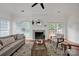 Bright living room with large windows, fireplace, and access to the outdoor deck at 16013 Wynfield Creek Pkwy, Huntersville, NC 28078