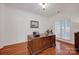 Home office with hardwood floors, a large window, and a spacious desk, perfect for working from home at 16013 Wynfield Creek Pkwy, Huntersville, NC 28078