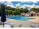 A community pool with lap lanes, lounge chairs, and umbrella-covered tables at 16013 Wynfield Creek Pkwy, Huntersville, NC 28078