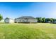 Expansive backyard view with a back deck, storage shed, and lush green lawn at 17438 Purser Dr, Locust, NC 28097