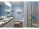 Bathroom with granite countertops, double sinks, and glass-enclosed shower at 17438 Purser Dr, Locust, NC 28097